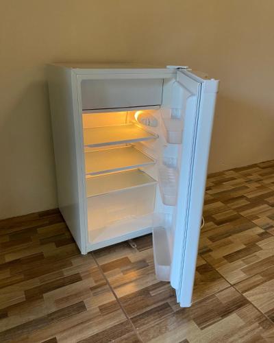 an empty refrigerator with its door open in a room at Mirians Place Drake in Drake