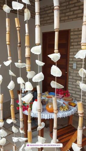 a table with white umbrellas and a table with food at Beach house Suites in Jericoacoara