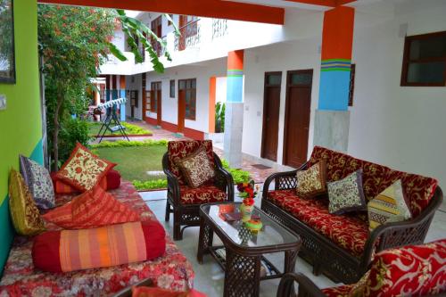 a living room with couches and a table at Hotel Harmony in Khajurāho