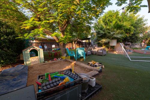 a backyard with a play area with a playground at רגע ערבה in ‘En Yahav