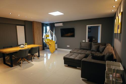 a living room with a couch and a table at Thome Arena Residence in Cluj-Napoca
