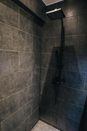 a bathroom with a shower with a shower head at Thome Arena Residence in Cluj-Napoca