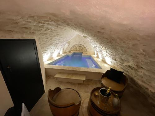 a bathroom with a blue tub in a cave at LE SPA INSOLITE DE MALAUCENE in Malaucène
