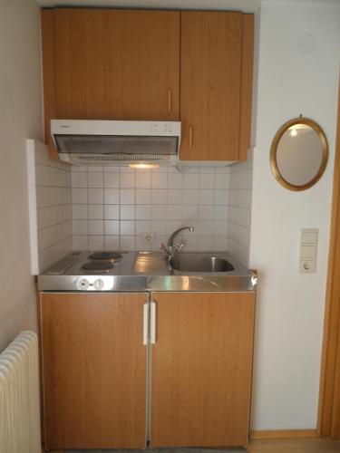 a kitchen with a sink and a stove at Alpenhaus Waldberg in Schruns
