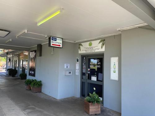 a building with a ticket machine in a hallway at Queens Beach Hotel in Bowen