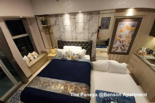 a bedroom with two beds in a room at The Paneya @Benson Apartment in Surabaya
