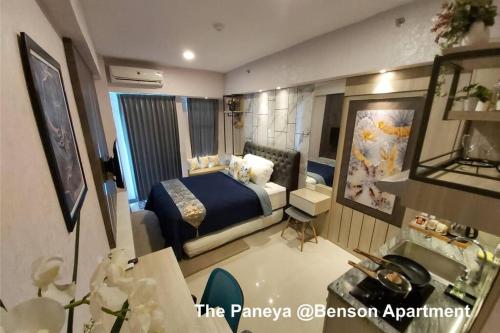 a hotel room with a bed and a bathroom at The Paneya @Benson Apartment in Surabaya