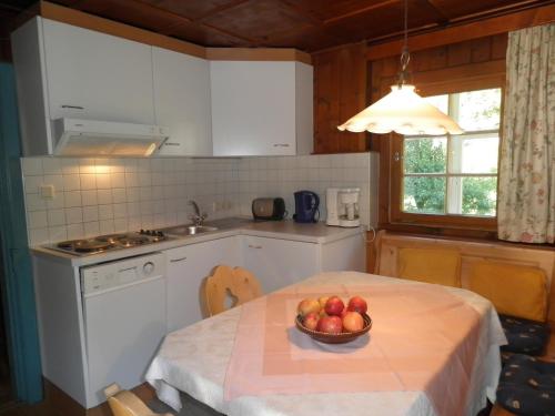 a kitchen with a table with a bowl of fruit on it at Alpenhaus Waldberg in Schruns