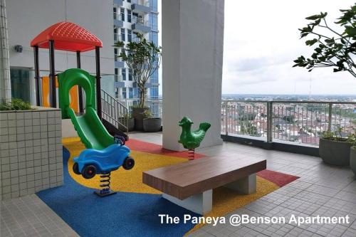 a childrens playground with a bench on a balcony at The Paneya @Benson Apartment in Surabaya