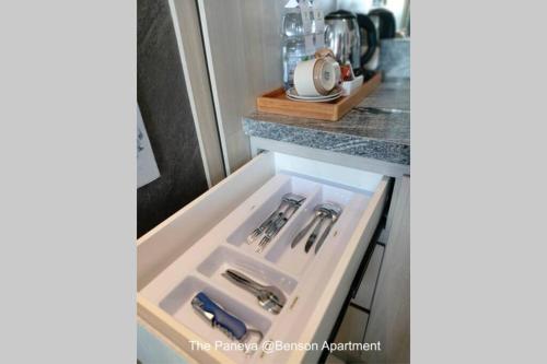 a drawer in a kitchen with utensils in it at The Paneya @Benson Apartment in Surabaya