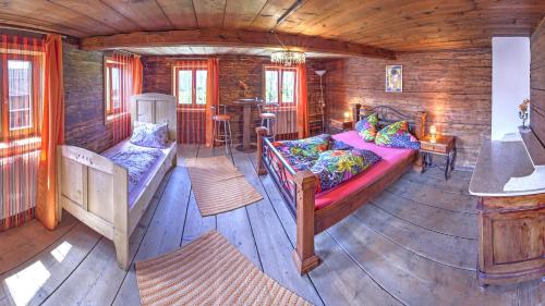 a bedroom with a bed in a wooden cabin at Chalet Rastenhof - Urlaub auf dem Bauernhof in Österreich in Gallzein