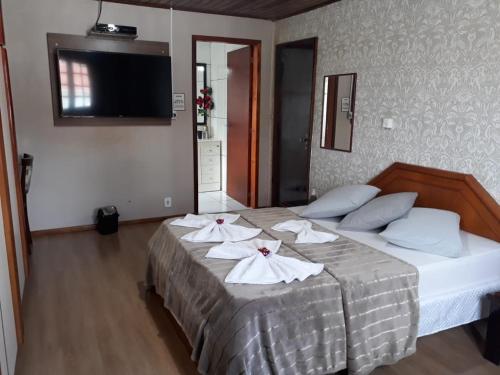 Ein Bett oder Betten in einem Zimmer der Unterkunft Pousada Cravo e Canela SJ