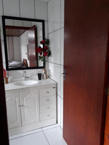 a bathroom with a sink and a mirror at Pousada Cravo e Canela SJ in São Joaquim