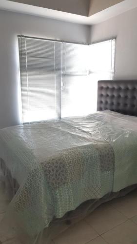 Postel nebo postele na pokoji v ubytování Apartemen Newton Kayla