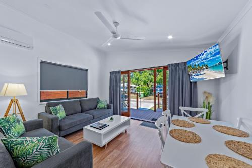 a living room with a couch and a table at BIG4 Whitsundays Tropical Eco Resort in Airlie Beach