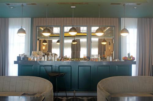 a bar in a restaurant with a blue counter at Sutasoma Hotel in Jakarta