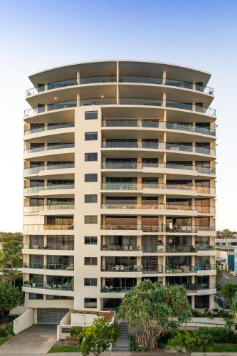 a large white building with trees in front of it at The Waterford Prestige Apartments in Caloundra