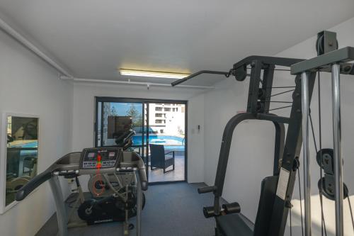 a room with a gym with a treadmill at Victoria Square Apartments in Gold Coast