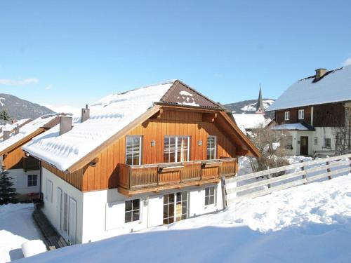 a house in the snow with snow covered roofs at Chalet in St Margarethen with sauna near ski area in Sankt Margarethen im Lungau
