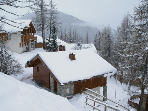 a cabin with snow on the roof of it at Charming chalet with view on Mont Blanc in Peisey-Nancroix