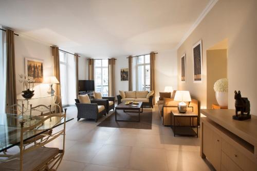 a living room with couches and chairs at Cannes Croisette Prestige Apart'hotel in Cannes