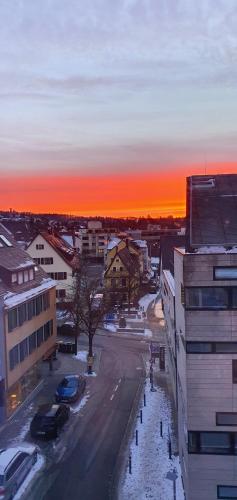 a view of a city with the sunset in the background at BB City Hotel in Böblingen