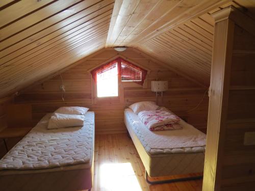 מיטה או מיטות בחדר ב-Arctic Polar Holiday Village