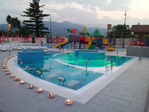 a large swimming pool with a playground at Hotel Villa Glicini in Pinerolo