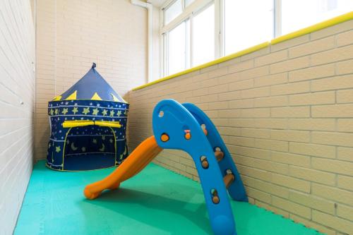 a childs play room with a blue slide at Sky Bird Garden B&B in Wujie