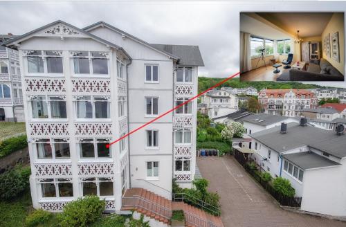 a white house with a red line separating it from a city at Meerforelle 207 - Villa Seeblick in Sassnitz