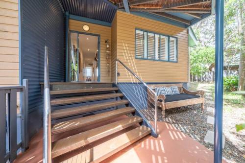 a home with wooden stairs leading to the front porch at Saltwater 5 - sleeps 8 - close to Main Beach in Point Lookout