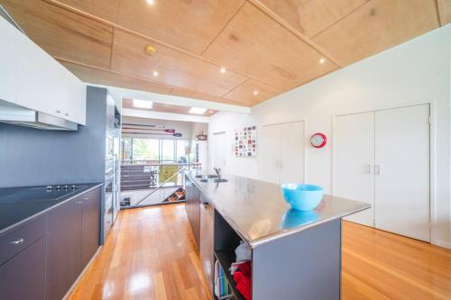 a kitchen with a large island with a blue bowl on it at Saltwater 5 - sleeps 8 - close to Main Beach in Point Lookout