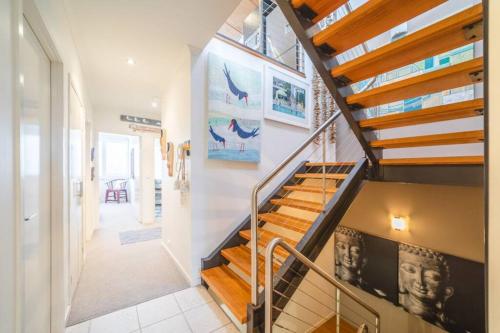 a staircase in a home with wooden steps at Saltwater 5 - sleeps 8 - close to Main Beach in Point Lookout