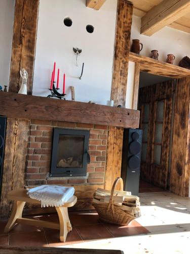 a living room with a brick fireplace and a bench at Vojnův Městec Dům s vůní dřeva in Žďár nad Sázavou