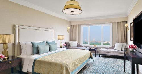 a hotel room with a bed and a large window at Taj Mahal, New Delhi in New Delhi