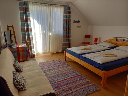 a bedroom with two beds and a large window at Apartment Sandra in Obertraun