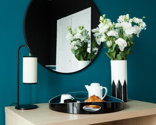 a table with a plate of food and a mirror at Hotel Saint Louis in Brest