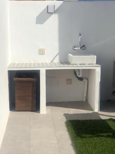 a bathroom with a sink and a white counter at Ático a 200m del mar. in Jávea
