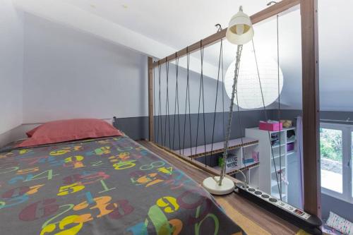 a bedroom with a bed and a staircase at Villa élégante à Saint-Paul avec piscine privée ouverte toute l'année in Saint-Paul