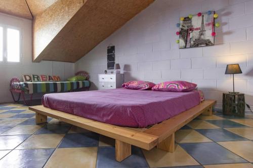 a bedroom with a bed with a purple bedspread at Villa élégante à Saint-Paul avec piscine privée ouverte toute l'année in Saint-Paul