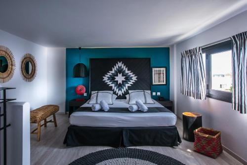 a bedroom with a large bed with blue walls at Indigo Inn in Hersonissos