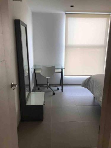 a bedroom with a desk and a bed and a mirror at Luxury house with all the amenities Gym Seg Aa cal Pool Tv Wifi in Querétaro