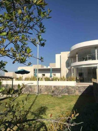 a large building with a statue in front of it at Luxury house with all the amenities Gym Seg Aa cal Pool Tv Wifi in Querétaro