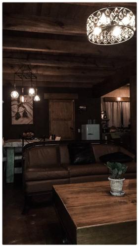 a living room with a couch and a table at Beautiful Cabin Downtown Tapalpa Oven Mud Barbecue Grill 4 Room 12 ppl TV Wifi in Tapalpa