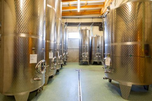 eine Reihe von Weinfässern in einer Brauerei in der Unterkunft Weingut und Gästezimmer Perner in Ehrenhausen