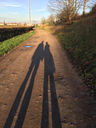 two shadows of people standing on a dirt road at Hanzestadslogement "De Leeuw", logies in het centrum van Deventer in Deventer