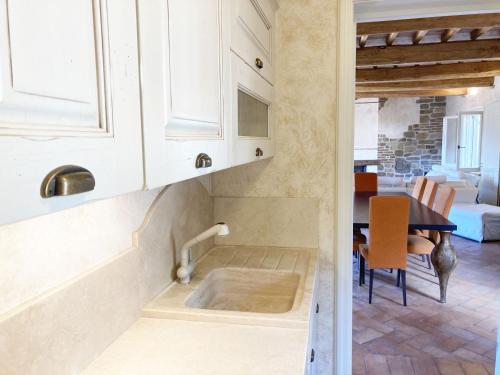 a kitchen with a sink and a table at Villetta Paradiso in Portoferraio