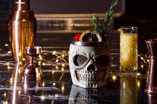 a skull cup on a table with a drink at Hotel Indigo Phuket Patong by IHG in Patong Beach