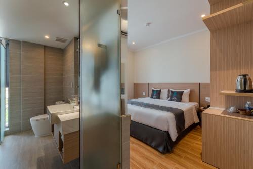 a hotel room with a bed and a sink at The Empire Hotel in Phu Quoc