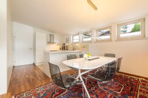 a dining room with a white table and chairs at Pension Seehof Appartements in St. Wolfgang